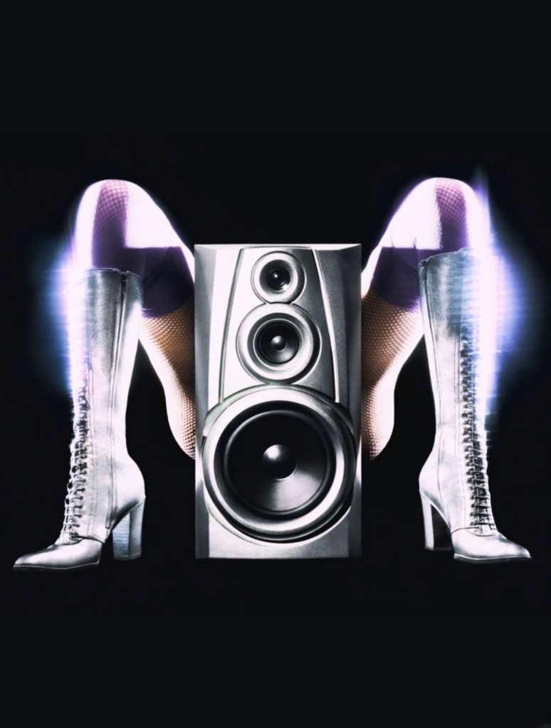 A dynamic image featuring a large speaker positioned between the legs of a person wearing striking silver high-heeled boots, with the background in dark tones for emphasis.
