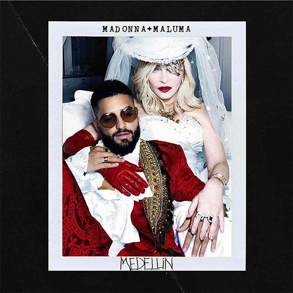 A promotional image featuring Madonna in a wedding dress with a veil and glamorous makeup, sitting beside Maluma, who is wearing sunglasses and a red ornate jacket. The background has a dark border with the text 'MADONNA + MALUMA' and 'MEDELLÍN'.