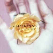 A hand holding a yellow rose with a soft pink background and the text 'MADONNA - BEDTIME STORY' centered above.