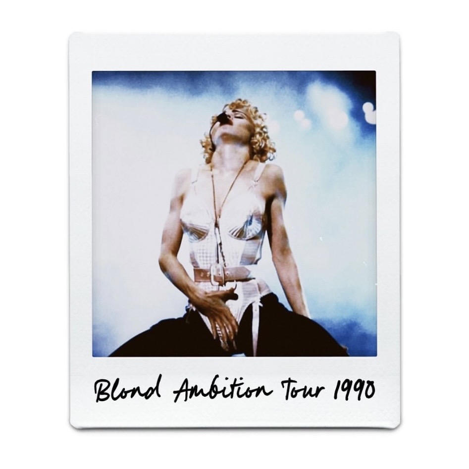 A performer on stage during the Blond Ambition Tour in 1990, wearing a striking costume and posed dramatically.