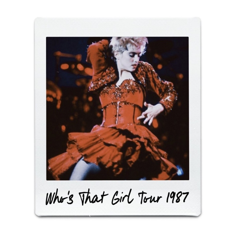 A performer in a sparkling red dress dancing on stage during the 'Who's That Girl Tour' in 1987.