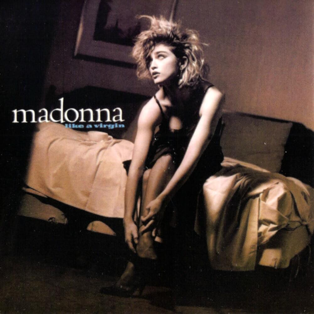 Album cover of Madonna's 'Like a Virgin', featuring a black and white image of a woman in a black dress sitting on a bed, looking away with a pensive expression.