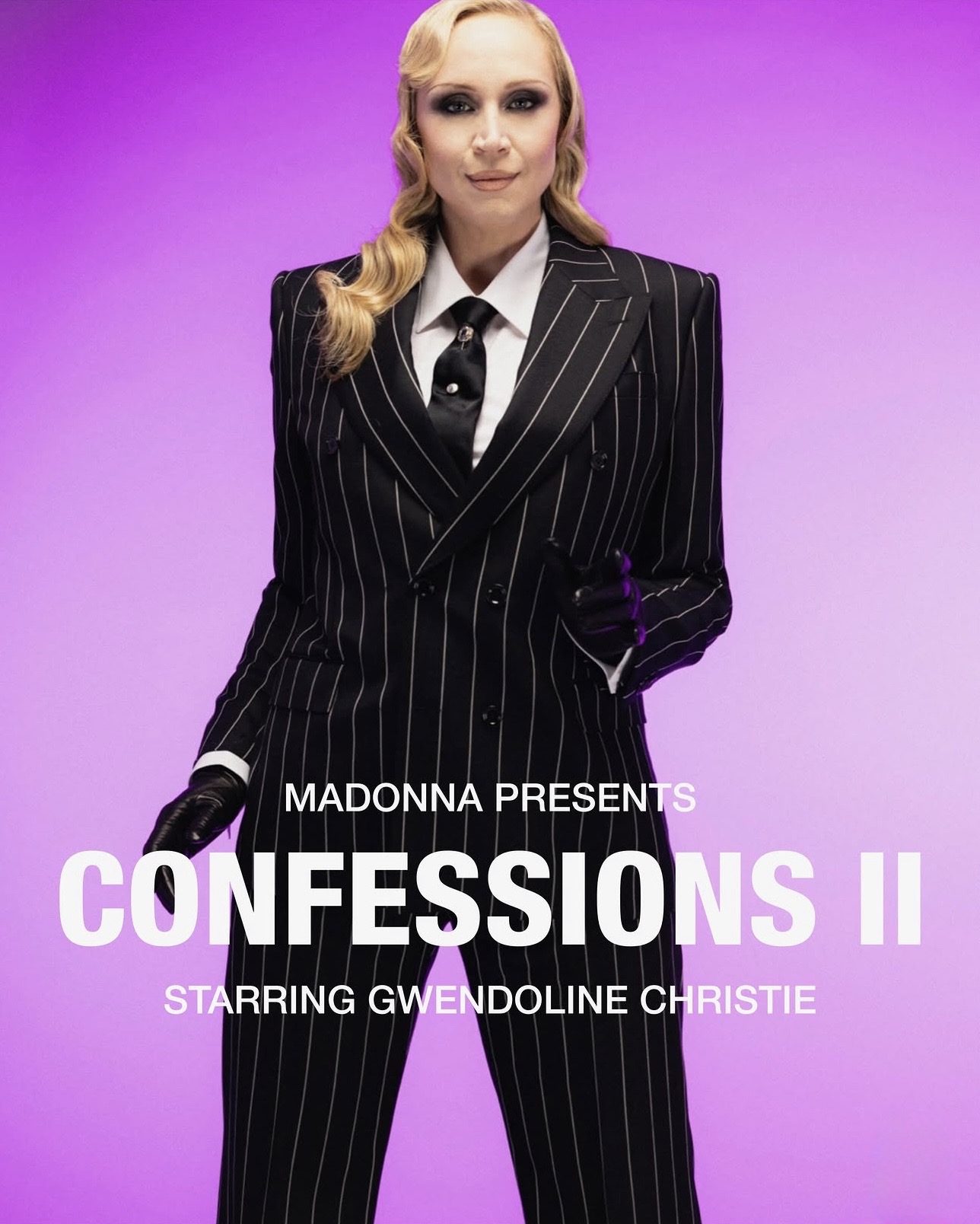 A person wearing a black pinstripe suit and gloves poses confidently against a vibrant purple background, promoting 'Confessions II' starring Gwendoline Christie.