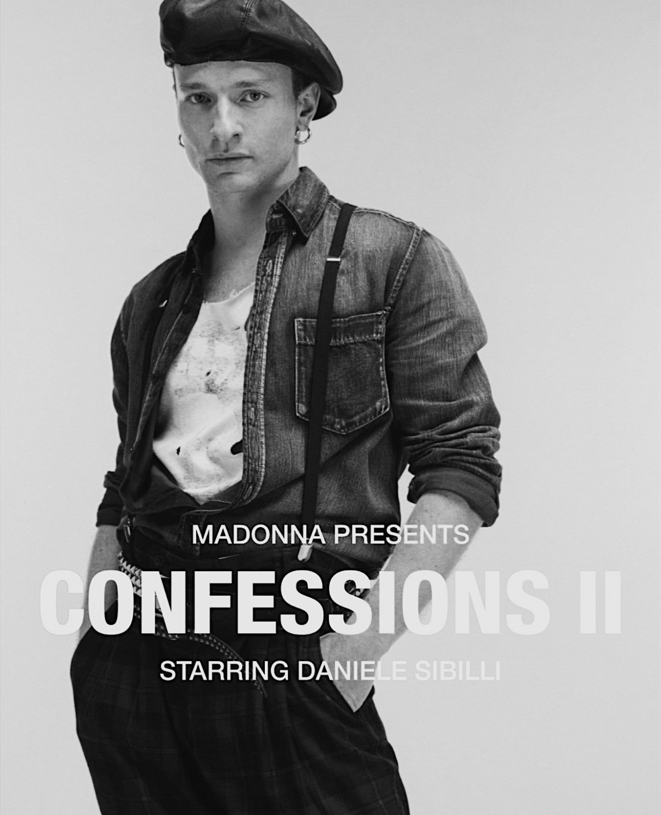 A black and white portrait of a male model wearing a beret, denim shirt, and suspenders, featuring the text 'Madonna Presents Confessions II Starring Daniele Sibilli' prominently displayed.
