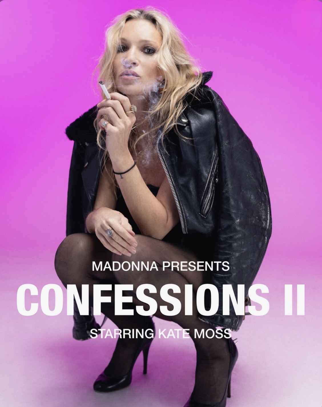 A woman with long, wavy blonde hair sits against a vibrant pink background, holding a cigarette. She wears a black leather jacket and sheer black tights, showcasing a confident expression.