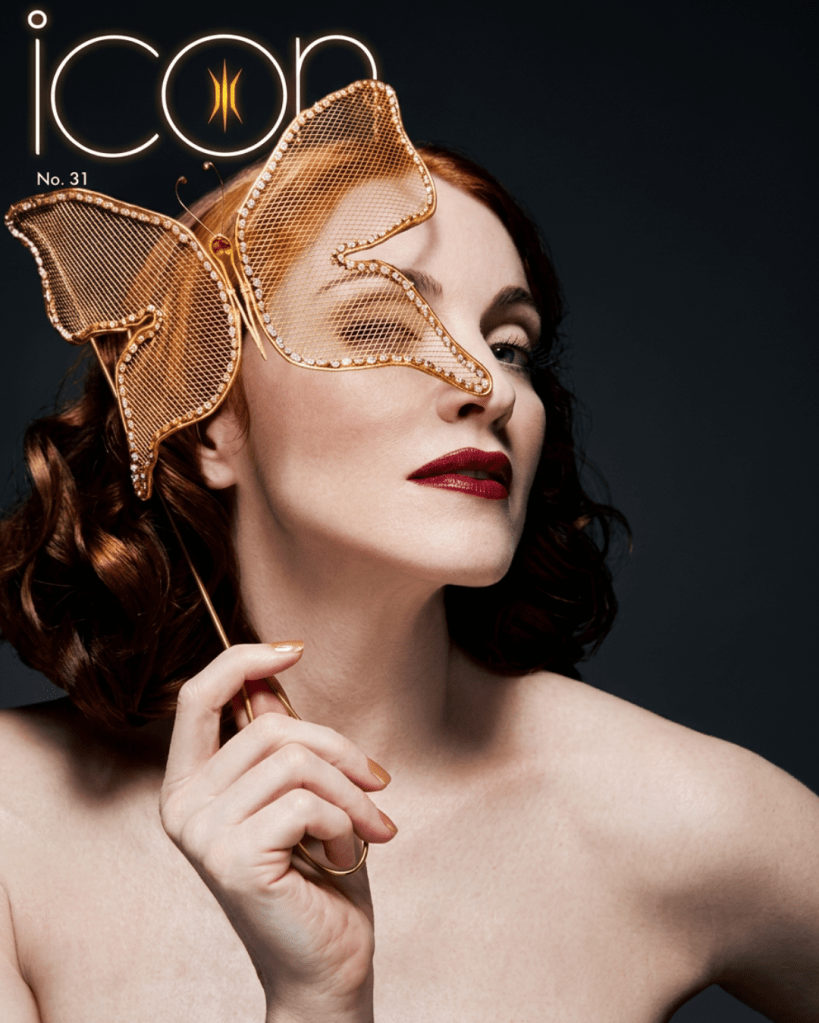 A woman with red hair poses elegantly, holding a gold butterfly-shaped accessory over her eye, with bold red lipstick and a bare shoulder against a dark background. The magazine title 'icon' and the issue number 'No. 31' are visible at the top.